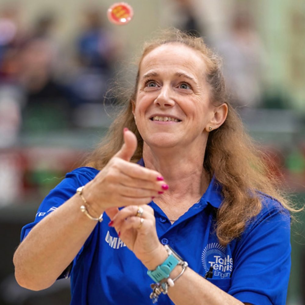 Photo of Sandy as a table tennis umpire tossing coin Photo by Michael Loveder Photography
